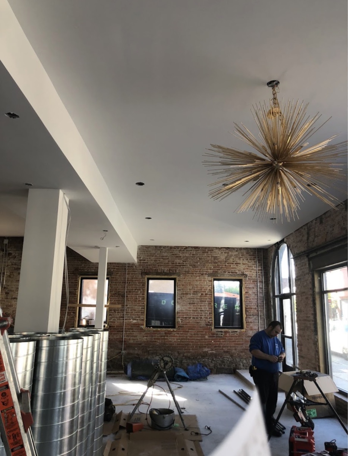 Commercial space with smooth finished ceiling and exposed brick walls
